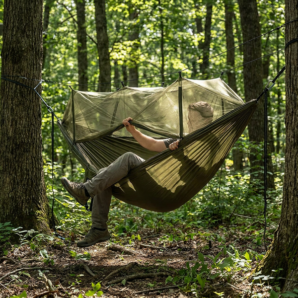 Relaxing in the packable camping hammock with mosquito net